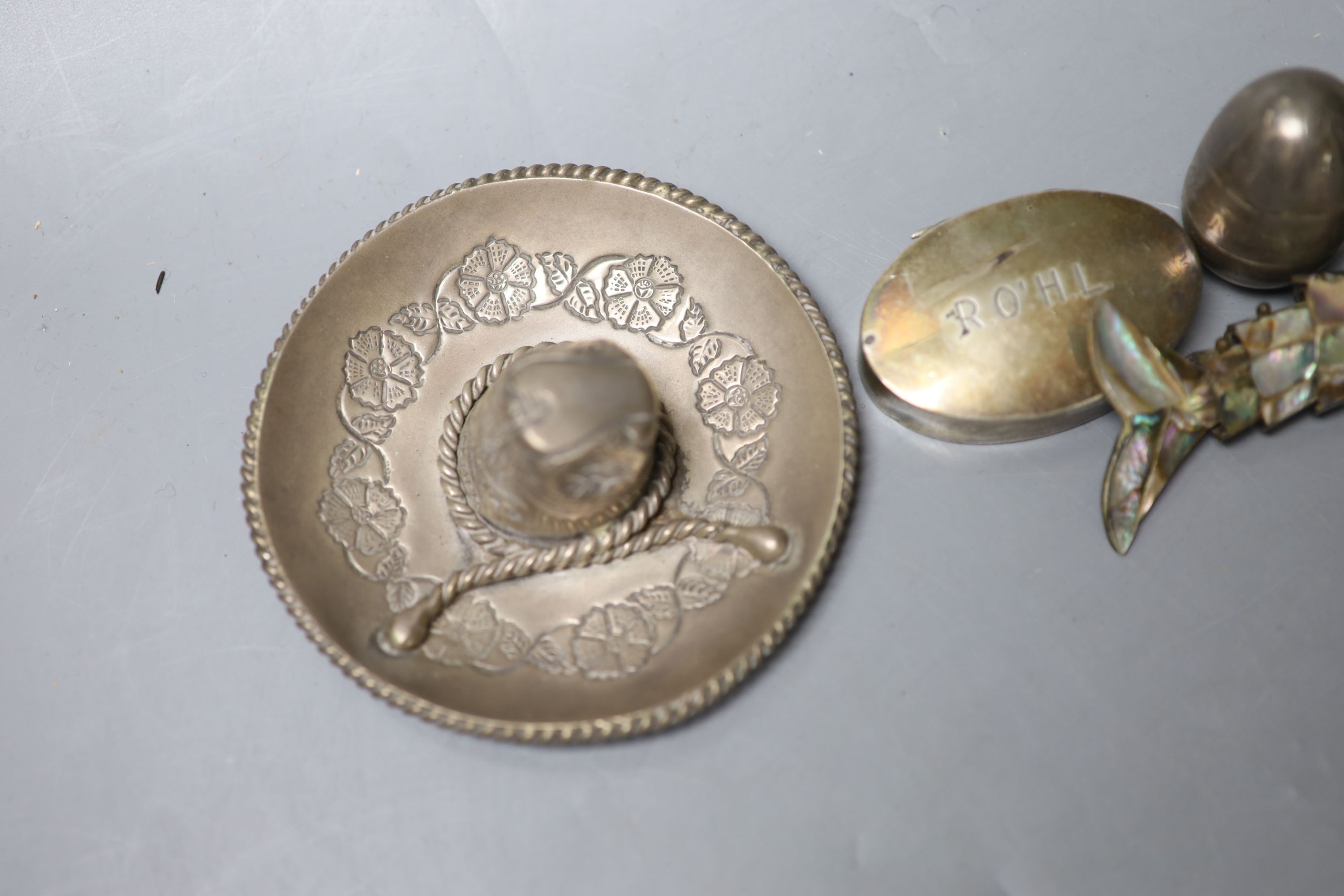 A silver and ivory baby's rattle with teething ring and a Mexican sterling 'hat' snuffer and three other items, including a mother of pearl mounted articulated fish and a silver pill box.